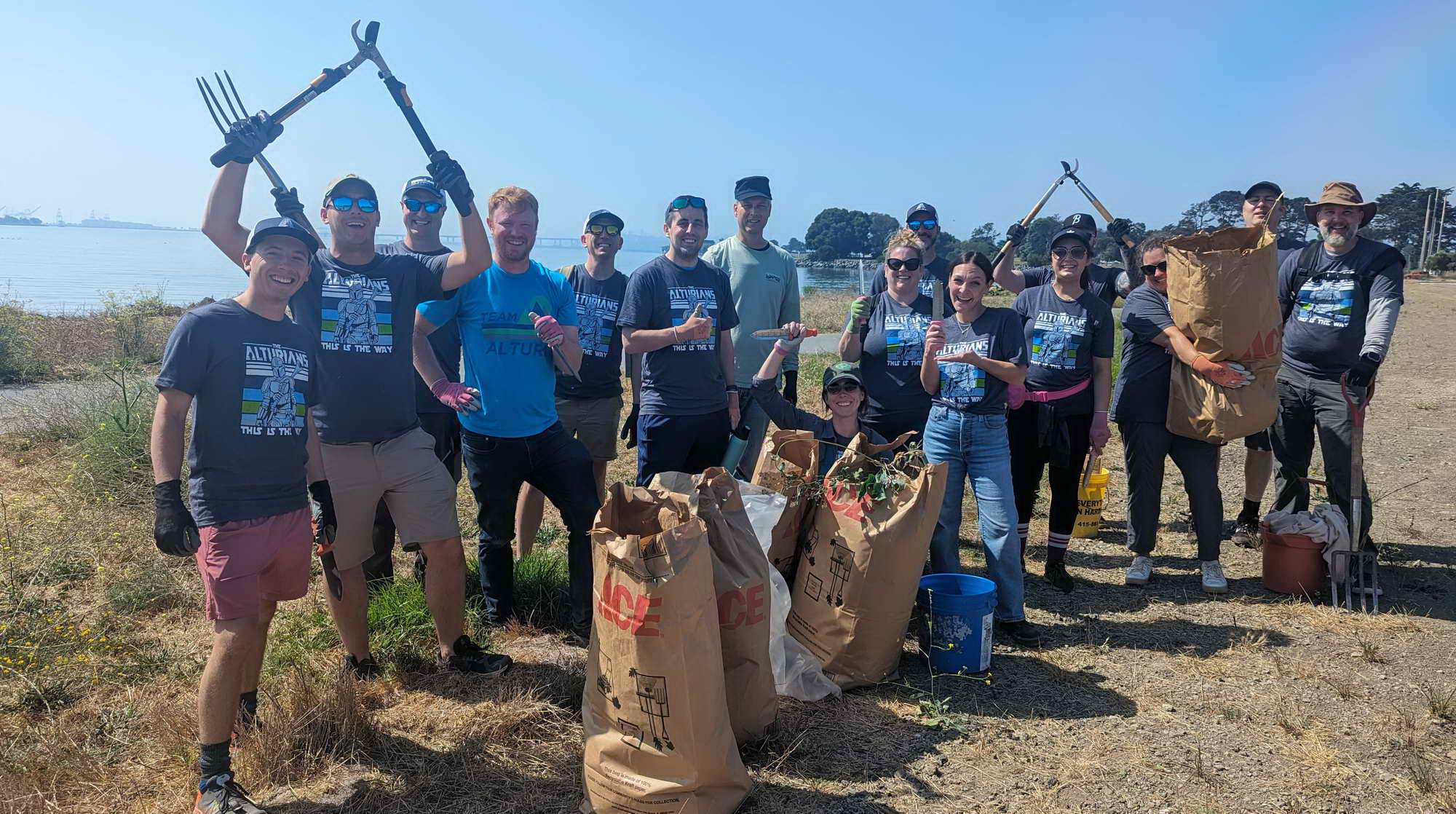 Volunteers with full bags of invasive pepperweed near Strawberry Creek mouth